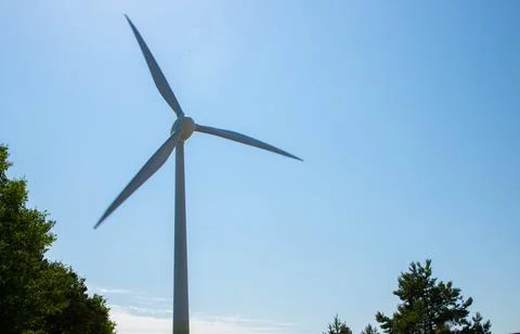 Windmill for electricity generation the background of a blue sky. Stock Photos