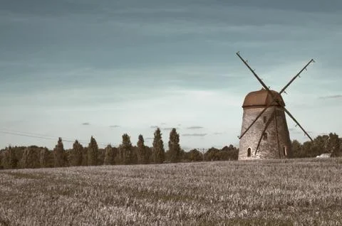 Windmill on farm field Stock Photos