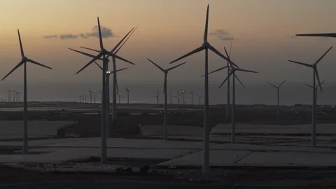 Windmill farm generating clean and renewable electricity at sunset. Modern wind Stock Footage 339795120