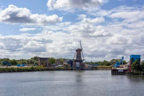 Windmill farm river landscape. Windmill farm scene. Village windmill farm Stock Photos