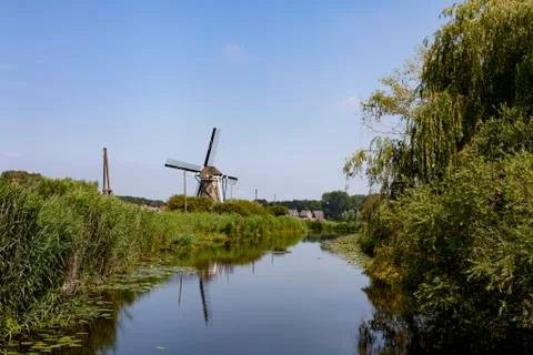 Windmill farm river landscape. Windmill farm scene. Village windmill farm Stock Photos