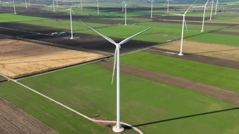 Windmill Farm in Wide Open Field Generating Sustainable Energy Stock Footage 264682189
