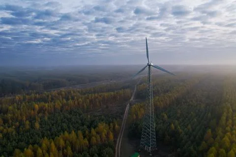 Windmill with a fixed propeller in the countryside against the background of the 스톡 사진