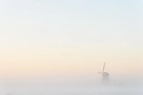 Windmill in the fog Stock Photos
