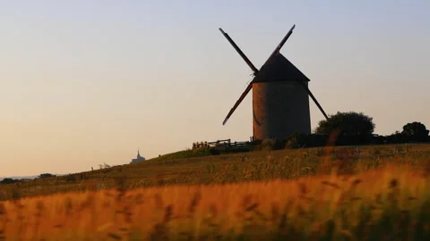 Windmill in the Foreground and Revealing High Castle in the Distance Video stock 280366714