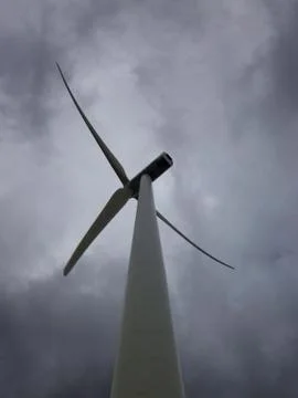 Windmill generating electricity on a cloudy day with a lot of wind Stock Photos