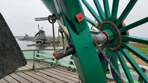 Windmill inner cogs turning due to the wind in the Netherlands - Zaanse Schans Stock Footage 127030371