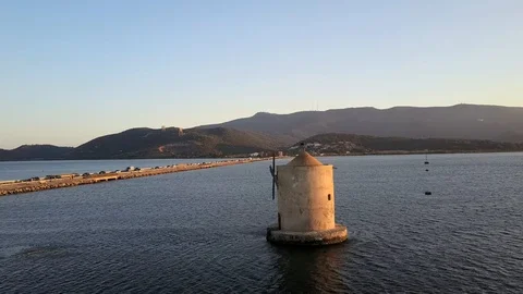Windmill in a lagoon at sunset Stock Footage 122850247