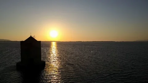Windmill in a lagoon at sunset Stock Footage 122850321