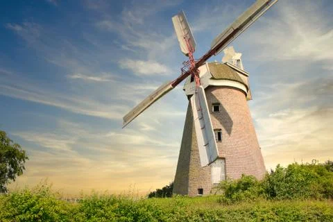 Windmill located on a field in the sunset Stock Photos