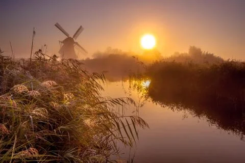 Windmill in marshland Stock Photos