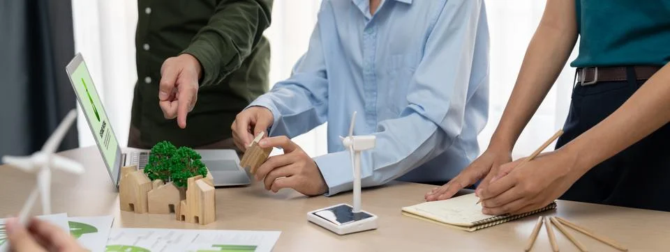 Windmill model and environmental document was placed at table. Delineation. Stock Photos