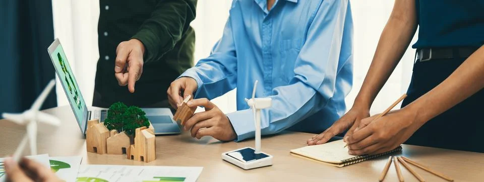 Windmill model and environmental document was placed at table. Delineation. Stock Photos