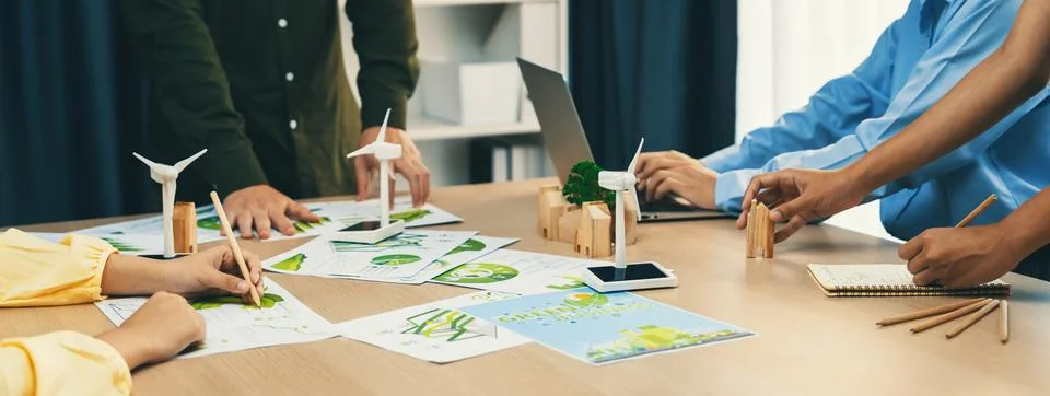 Windmill model and environmental document was placed at table. Delineation. Stock Photos