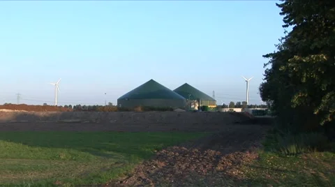 Windmill next to biogas installation - wider Stock Footage 5700893