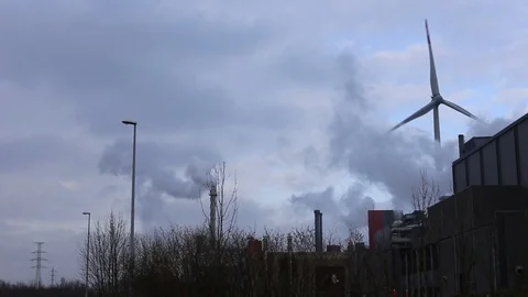 Windmill next to a factory Stock Footage 123732607