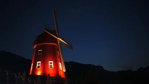 Windmill at night with mountains in the background. 動画素材 107981708