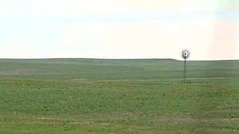 Windmill in open grass field Stock Footage 156555821