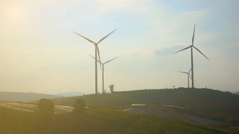 Windmill or wind turbine on sunset mountain golden blue sky and cloud Video stock 95129689