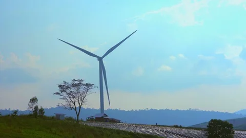 Windmill or wind turbine on sunset mountain golden sky and cloud, A wind turbine Video stock 95132340