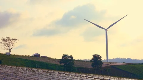 Windmill or wind turbine on sunset mountain golden sky and cloud Stock Footage 95149426