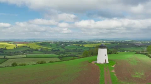 Windmill over fields and farms from a drone, Torquay, Devon, England 動画素材 255962260