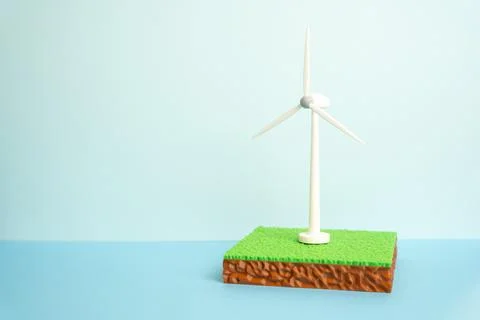 Windmill on a plot of land represents green energy development. Renewable pow Stock Photos