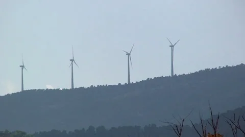 Windmill power generators on mountain crest Stock Footage 49964355