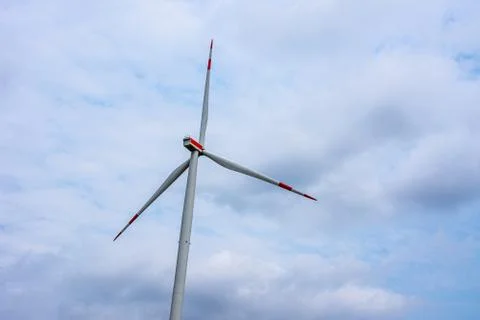 Windmill with the red stripes on a cloudy day Stock Photos