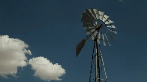 A windmill in a remote area of a western desert Stock Footage 33898392