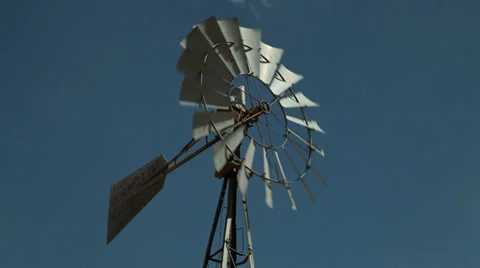 A windmill in a remote area of a western desert Stock Footage 33898669