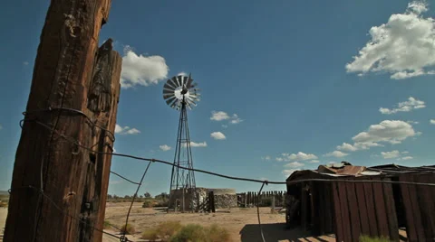 A windmill in a remote area of a western desert Stock Footage 33899120