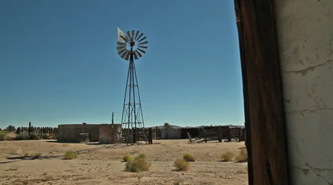 A windmill in a remote area of a western desert Stock Footage 33899209