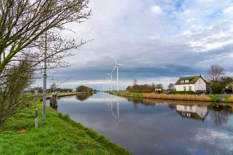 Windmill at the river Stock Photos