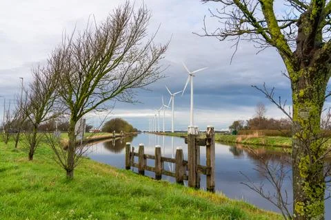 Windmill at the river Stock Photos