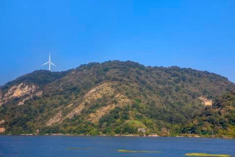 Windmill on the riverside Stock Photos