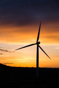 Windmill silhouette at sunset Stock Photos