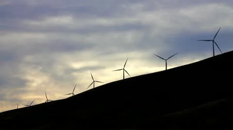 Windmill silhouettes with sunset clouds in background Stock Footage 11411348