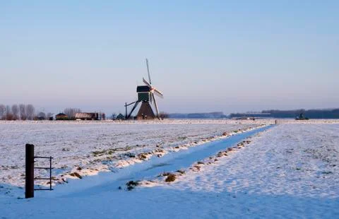 Windmill in a snow covered landscape Foto stock