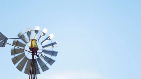 Windmill spinning against a blue sky Stock Footage 262294461