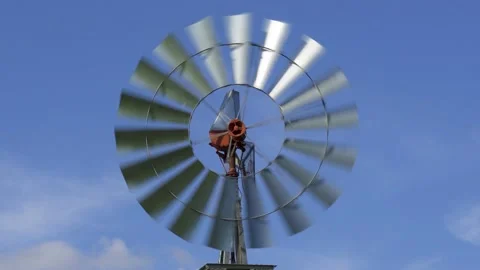 Windmill spinning fast on windy day, against blue sky - Davie, Florida, USA Stock Footage 187237844