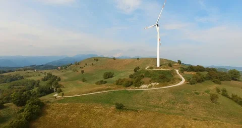 Windmill spinning on a hill in the countryside Stock Footage 91712266
