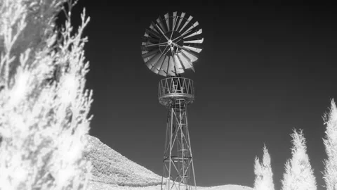 Windmill spinning in an infrared timelapse Stock Footage 345178818