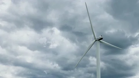 The windmill is spinning slowly, producing environmentally friendly, green en Stock Footage 133173362