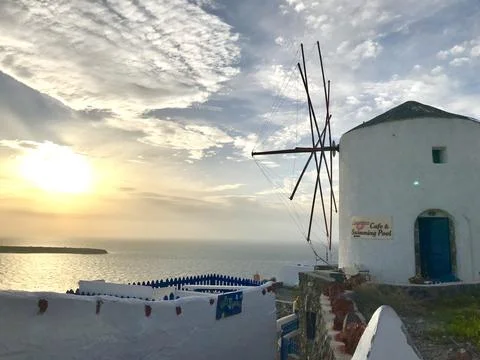 Windmill with sunset background at Santorini Stock Photos