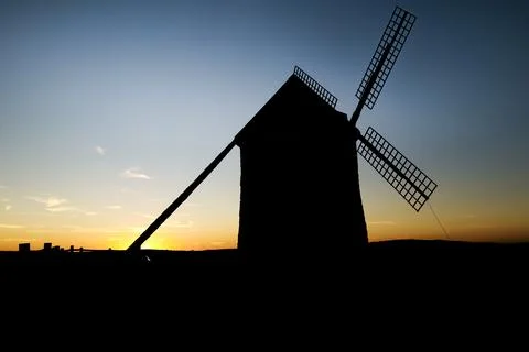 Windmill at sunset in Cerro de San Juan hill in Pozo Canada town, Castilla .. Stock Photos