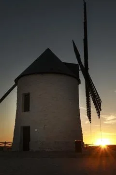 Windmill at sunset in Cerro de San Juan hill in Pozo Canada town, Castilla .. Stock Photos