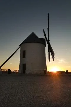 Windmill at sunset in Cerro de San Juan hill in Pozo Canada town, Castilla .. Stock Photos