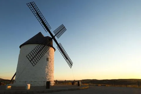 Windmill at sunset in Cerro de San Juan hill in Pozo Canada town, Castilla .. Stock Photos