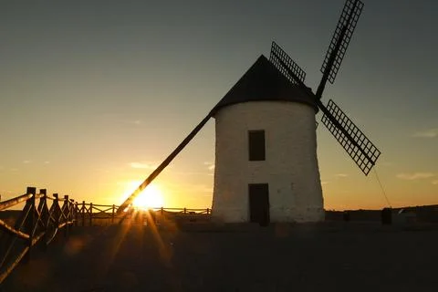 Windmill at sunset in Cerro de San Juan hill in Pozo Canada town, Castilla .. Stock Photos